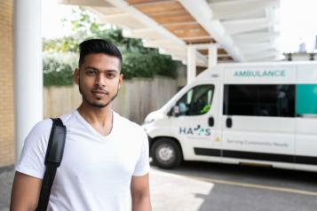 Man standing infront of an ambulance