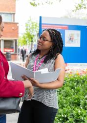 Two women talking outside a hospital